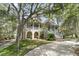 Stunning two-story home with mature trees and a wrap-around porch and elegant stairway entry at 4702 Blockhouse Ln, Hollywood, SC 29449