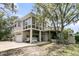 Unique coastal home featuring multi-car garage, balcony, and a wall of windows providing ample natural light at 4702 Blockhouse Ln, Hollywood, SC 29449