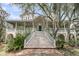 Beautiful home with elegant staircase leading to a covered porch, surrounded by lush landscaping at 4702 Blockhouse Ln, Hollywood, SC 29449