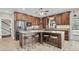 Kitchen with a granite island, wood cabinets, and stainless steel appliances at 4702 Blockhouse Ln, Hollywood, SC 29449