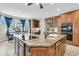 Bright kitchen features an island with cooktop, wood cabinets, and a breakfast nook by the window at 4702 Blockhouse Ln, Hollywood, SC 29449