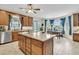 Well-lit kitchen with a large island, wooden cabinets, and a view to the outdoors at 4702 Blockhouse Ln, Hollywood, SC 29449