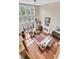 Bright living room with high ceilings, a fireplace, and large windows offering great natural light at 4702 Blockhouse Ln, Hollywood, SC 29449