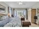 Main bedroom with an adjacent sunroom, rattan furniture, and bright natural light at 4702 Blockhouse Ln, Hollywood, SC 29449