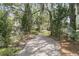 Picturesque gravel pathway winding through lush greenery, creating a serene and inviting outdoor space at 4702 Blockhouse Ln, Hollywood, SC 29449