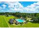 Aerial view of a community pool area with lounge chairs, surrounded by green spaces and beautiful blue sky at 4702 Blockhouse Ln, Hollywood, SC 29449