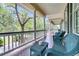 Inviting porch with wicker chairs and picturesque views of the surrounding landscape at 4702 Blockhouse Ln, Hollywood, SC 29449