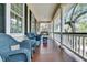 Relaxing porch with wicker seating and a swing, perfect for enjoying the peaceful outdoor setting at 4702 Blockhouse Ln, Hollywood, SC 29449