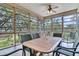 Relaxing screened porch features outdoor seating and views of the landscaped yard at 4702 Blockhouse Ln, Hollywood, SC 29449