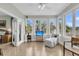Sunroom with hardwood floors, a ceiling fan, and windows offering a scenic view at 4702 Blockhouse Ln, Hollywood, SC 29449