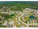 Aerial view of a residential area featuring single-Gathering homes, ponds, and lush greenery at 489 Dolphin Dr, Summerville, SC 29485