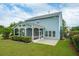 A spacious backyard featuring a screened porch, patio, and lush green grass at 489 Dolphin Dr, Summerville, SC 29485