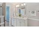 Bright bathroom featuring a double sink vanity with a white countertop and large framed mirror at 489 Dolphin Dr, Summerville, SC 29485