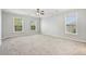 Expansive bedroom featuring plush carpeting, three windows, and neutral paint at 489 Dolphin Dr, Summerville, SC 29485