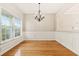 Sunlit dining room with hardwood floors, chandelier, and large windows at 489 Dolphin Dr, Summerville, SC 29485
