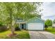 Charming two-story home with a well-manicured lawn, attached garage, and beautiful landscaping at 489 Dolphin Dr, Summerville, SC 29485