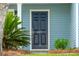 Close-up of the front door with dark wood finish, house number, and landscaped entryway at 489 Dolphin Dr, Summerville, SC 29485