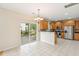 Eat-in kitchen boasts stainless steel appliances, breakfast bar, and screened-in porch access at 489 Dolphin Dr, Summerville, SC 29485