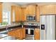 Well-lit kitchen featuring stainless steel appliances, wooden cabinets, and stylish countertops at 489 Dolphin Dr, Summerville, SC 29485