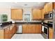 Charming kitchen with stainless steel dishwasher, light wood cabinets, and tile flooring at 489 Dolphin Dr, Summerville, SC 29485