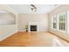 Spacious living room with hardwood floors, fireplace, and ample natural light from large windows at 489 Dolphin Dr, Summerville, SC 29485
