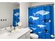 Whimsical bathroom with a unique blue whale-themed shower curtain, bright lighting, and modern fixtures at 5003 Ferry Field Dr, Summerville, SC 29485