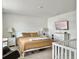 Bright primary bedroom with warm brown bedding, tv, rocking chair and crib offering comfort and style at 5003 Ferry Field Dr, Summerville, SC 29485