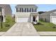 Charming two-story home with a well-manicured lawn and a two-car garage and inviting entrance at 5003 Ferry Field Dr, Summerville, SC 29485