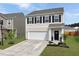 Charming two-story home with a well-manicured lawn and a two-car garage and inviting entrance at 5003 Ferry Field Dr, Summerville, SC 29485