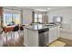 Bright kitchen with granite countertops and stainless steel dishwasher overlooking dining and living areas at 5003 Ferry Field Dr, Summerville, SC 29485