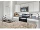 Well-equipped kitchen featuring granite countertops, stainless steel appliances, and ample cabinet space at 5003 Ferry Field Dr, Summerville, SC 29485