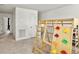 Open playroom area with carpet floors and a wooden climbing structure at 5003 Ferry Field Dr, Summerville, SC 29485
