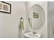 Elegant powder room with a stylish sink, round mirror, and tasteful decor for guests at 5003 Ferry Field Dr, Summerville, SC 29485