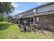 This backyard has a patio with furniture, a bike, and leads to a screened-in back porch at 506 Arlington Dr # F, Charleston, SC 29414