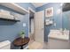 Bathroom featuring blue painted walls, toilet, sink and white shelving at 506 Arlington Dr # F, Charleston, SC 29414