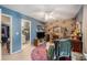 The bedroom has a floral design wallpaper accent wall, a ceiling fan and a view of the bathroom at 506 Arlington Dr # F, Charleston, SC 29414
