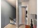 Upstairs hallway leading to carpeted stairs with an open doorway at 506 Arlington Dr # F, Charleston, SC 29414