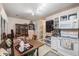 Charming dining area featuring a wooden table set for a meal, white cabinetry, and a dining bench at 506 Arlington Dr # F, Charleston, SC 29414