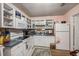 Traditional kitchen features white appliances, ample storage, and a charming floral backsplash at 506 Arlington Dr # F, Charleston, SC 29414