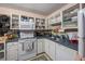 Cozy kitchen featuring white cabinets, floral wallpaper, and essential appliances at 506 Arlington Dr # F, Charleston, SC 29414