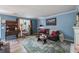 Cozy living room with blue walls, comfortable seating, and charming decor at 506 Arlington Dr # F, Charleston, SC 29414