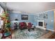 Cozy living room with a fireplace, blue walls, and comfortable seating at 506 Arlington Dr # F, Charleston, SC 29414