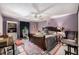 Main bedroom features an ornamental bed, ceiling fan and a view to the outside at 506 Arlington Dr # F, Charleston, SC 29414
