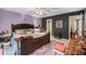 Spacious main bedroom with dark wooden bed frame, a view to the ensuite and ornamental decor at 506 Arlington Dr # F, Charleston, SC 29414
