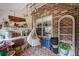 Cozy patio area with a hammock and brick wall, great for relaxing outdoors at 506 Arlington Dr # F, Charleston, SC 29414