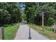 Community walking path with street sign. Includes foliage and an asphalt path at 506 Arlington Dr # F, Charleston, SC 29414