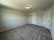 A well-lit bedroom features neutral walls, two white doors, carpeted floor, and a simple ceiling light at 5100 Double Eagle, Summerville, SC 29485