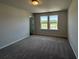 Bright bedroom with two windows overlooking a lush landscape view and neutral walls and brown carpet at 5100 Double Eagle, Summerville, SC 29485