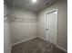 This closet offers ample storage with wire shelving, neutral walls and carpeted floor. A white door provides access at 5100 Double Eagle, Summerville, SC 29485