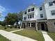 Charming two-story townhome featuring brick accents, black shutters, and a well-manicured lawn at 5100 Double Eagle, Summerville, SC 29485
